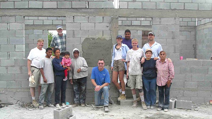 A team and a family in front of a completed house in Mexico