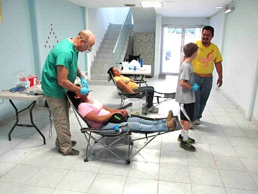 A dentist seeing patients at the clinic in Reynosa