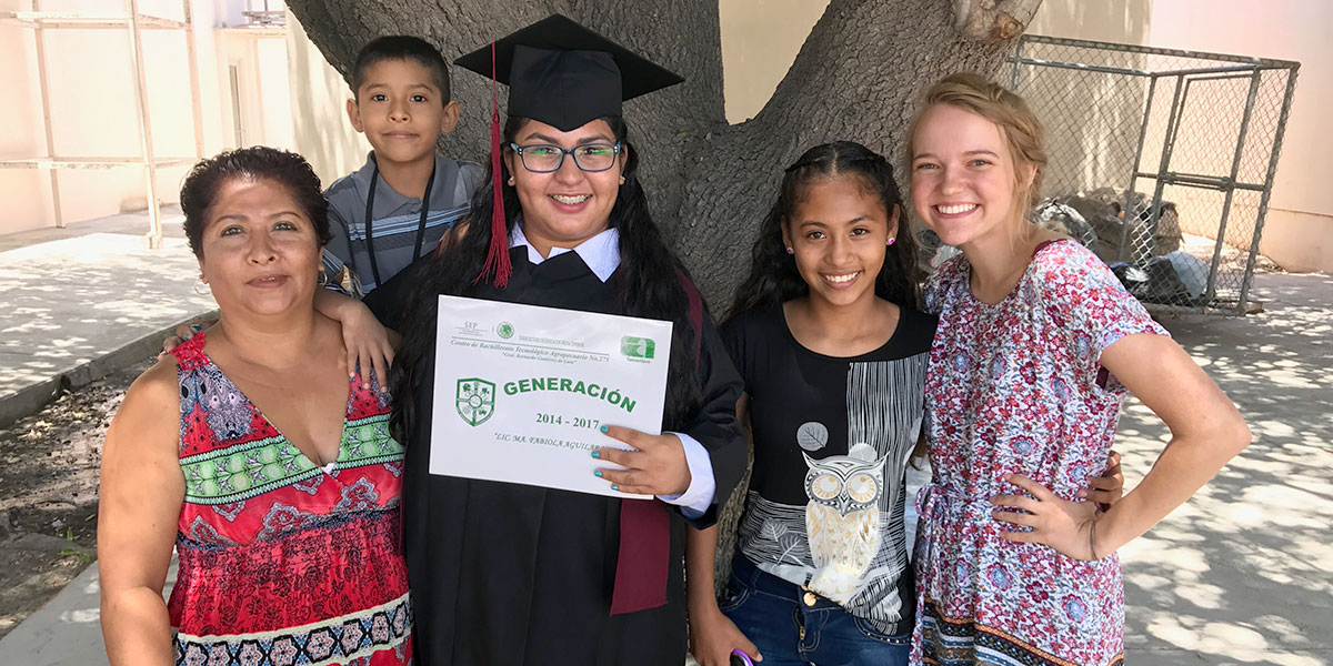 Our summer intern Emily with a student she helps sponsor at her high school graduation