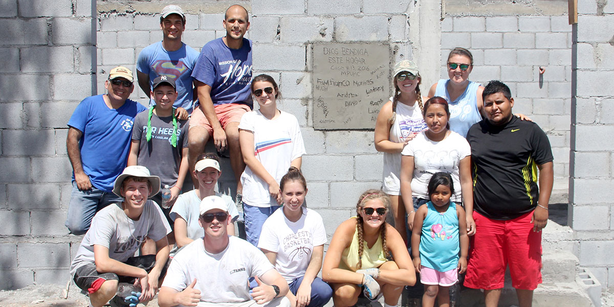 The team and family in front of the completed house in Mexico