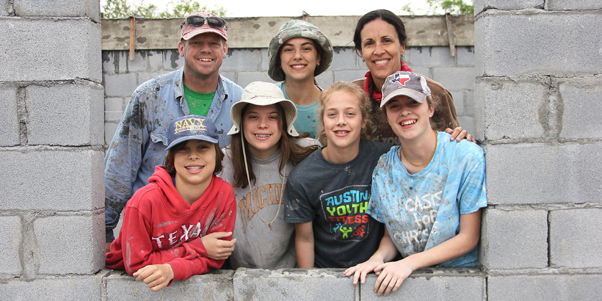 A family working together to build a house in Mexico