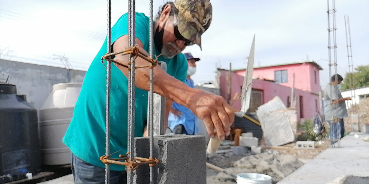 Lupe laying blocks at Casa 4 in Reynosa Mexico