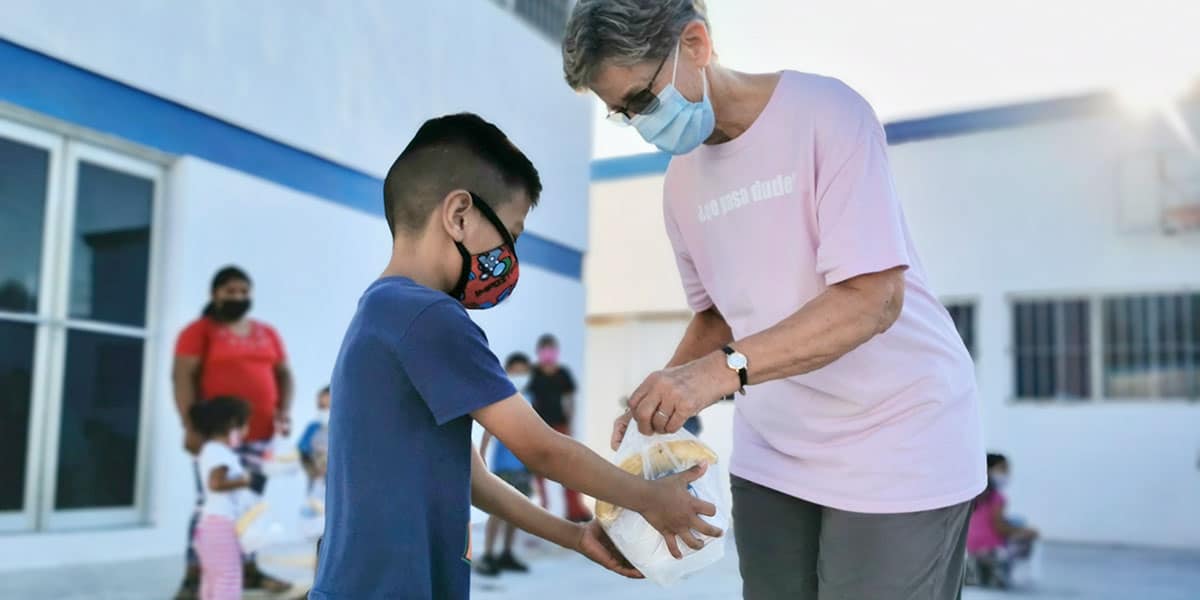 Helping hand out breakfast at the childrens nutrition program in Reynosa Mexico Helping hand out breakfast at the childrens nutrition program in Reynosa Mexico