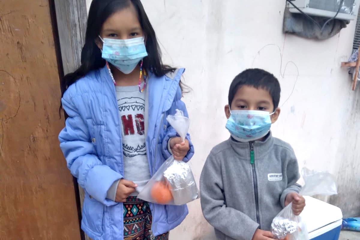 Distributing meals to kids in a rural community outside of Miguel Aleman Mexico