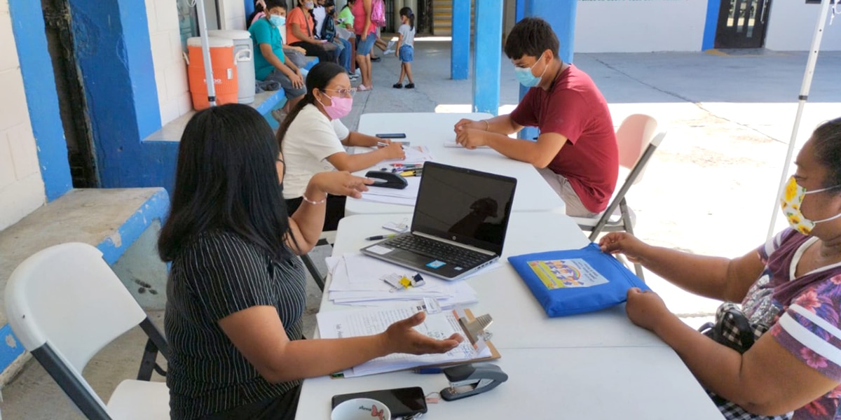The staff in Reynosa Mexico distributing the first scholarship checks of the school year to our scholarship students