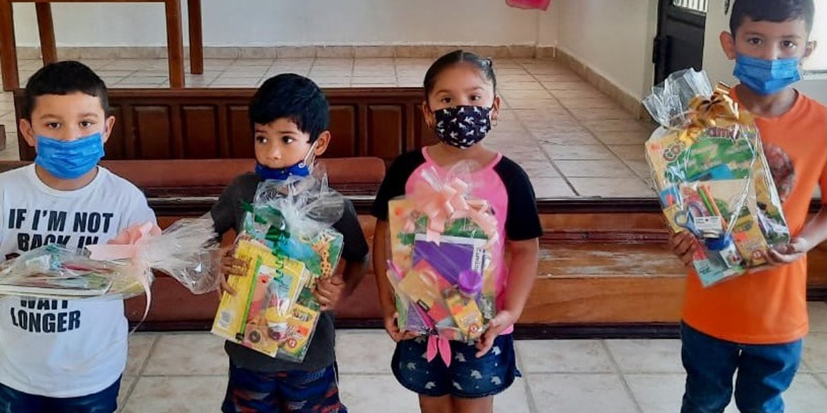 The students in Miguel Aleman Mexico receiving their school supply kits from the church congregation