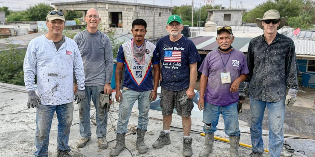 Friends from North Carolina Indiana Virginia and Reynosa pouring a roof together for a family in Mexico