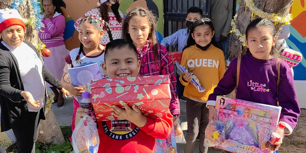 Kids with their gifts and candy from the Christmas fiesta in Naranjito Mexico