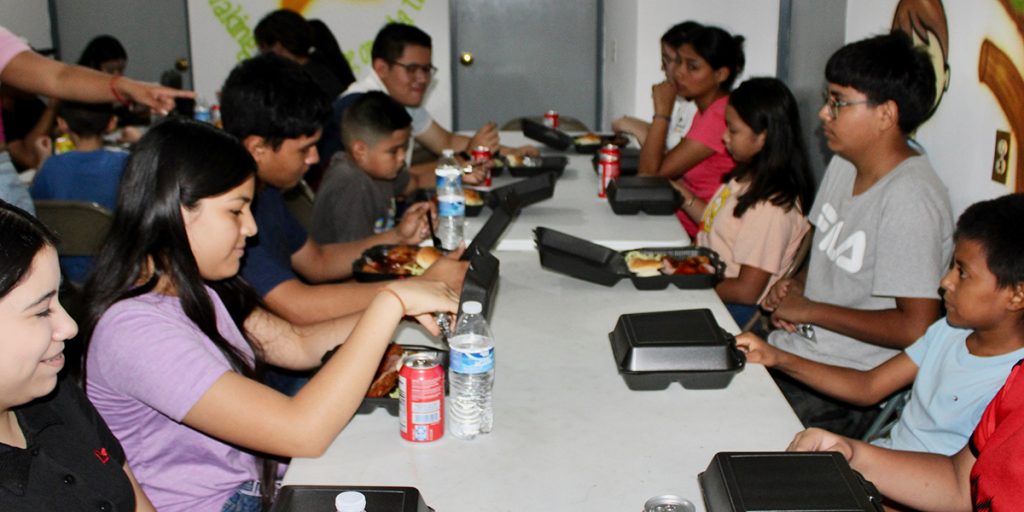 Students enjoying a meal at the back to school event in Miguel Aleman Mexico Students enjoying a meal at the back to school event in Miguel Aleman Mexico