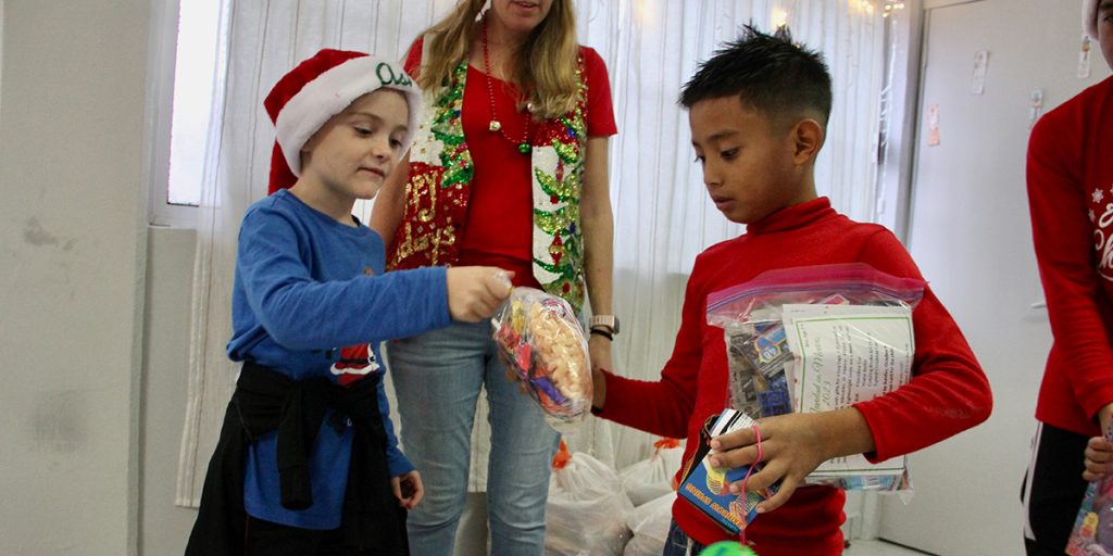 Giving out candy bags at our Christmas fiesta at our clinic in Reynosa Mexico