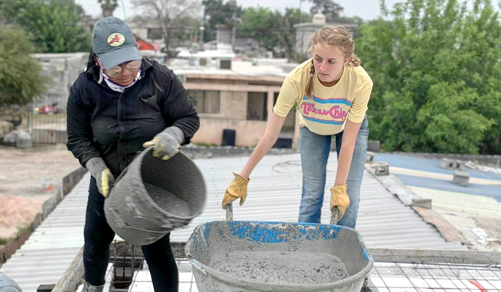 Friends from Reynosa and Austin working together to pour a roof for a family in Mexico