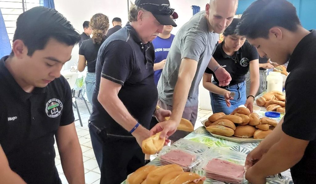 Friends from Charlotte NC working with the students of Berea Bible Institute to prepare sandwiches for the migrants in Monterrey Mexico